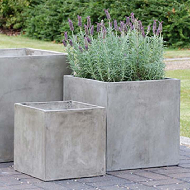 image of three different sized square pots one with lavender on a stoned ground